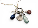 Necklace with various gemstone pendants on a white background