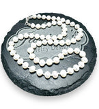 white high-grade pearls with sterling clasp strung on white silk.
