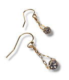 Gold earrings with gemstones on a white background