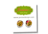 Jewelry card with round earrings featuring floral designs on a white background, branded 'Janine's Jewelry Design'.