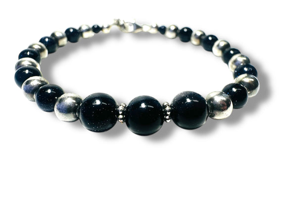Beaded bracelet with black and silver beads on a white background