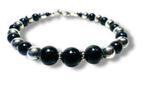 Beaded bracelet with black and silver beads on a white background