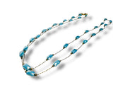 Turquoise beaded necklace on a white background
