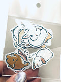 Set of animal stickers held by a hand with a clear plastic bag.