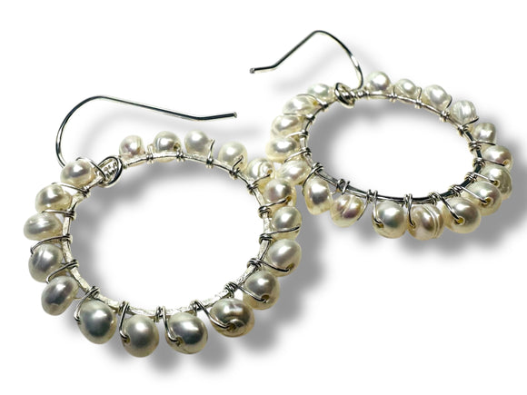 Pearl hoop earrings on a white background