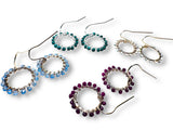 Set of circular gemstone beaded hoop earrings in various colors on a white background