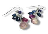 Multicolored gemstone earrings on a white background