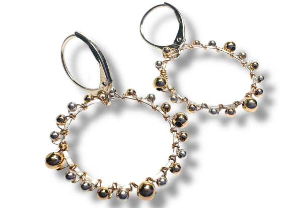 Pair of hoop earrings with bead detailing on a white background