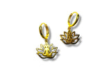 Gold lotus flower earrings on a white background