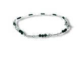 Bracelet with green goldstone beads on a white background