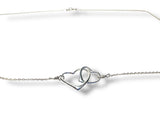 Silver bracelet with interlocking heart designs on a white background