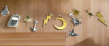 Collection of various metal pendants on a wooden surface