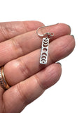 Moon Phase Earrings - silver metal cut out of a moon phase design -vertical design -sterling french hook earwires. shown in a hand for size comparison.