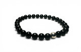 Black beaded bracelet with a silver clasp on a white background