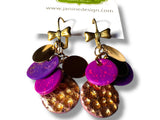 Colorful earrings with gold accents on a white background