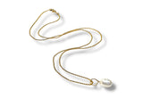 Gold necklace with a pearl pendant on a white background