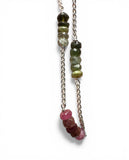 Necklace with green and pink bead chain on a white background