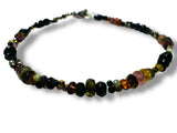 Necklace with multicolored tourmaline beads on a white background