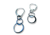 Pair of silver and blue hoop earrings on a white background