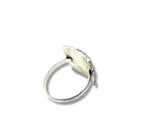 Silver ring with a leaf-shaped pendant on a white background