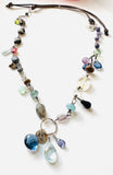 Festival Gemstone Necklace - mixed gemstones wire wrapped in a chain with a circle pendant and charms attached of gemstones.