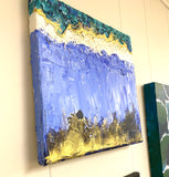 Painting on Canvas “Golden Ocean” - blue wave shapes with gold paint accents-shown hanging on a wall